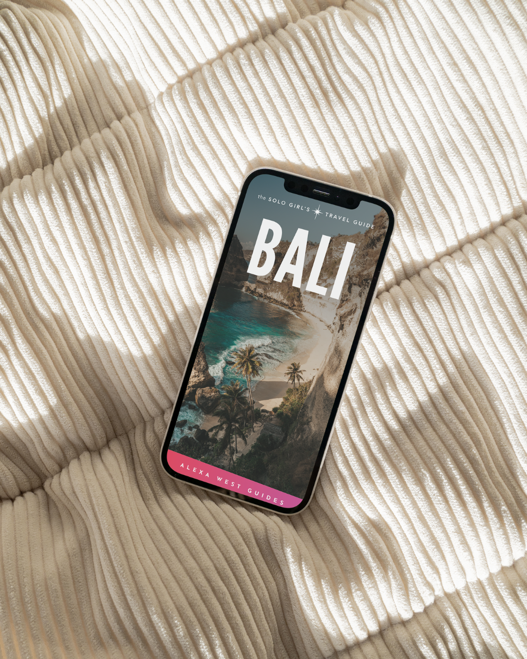 A promotional image featuring a smartphone displaying the cover of a Bali travel guidebook, with a beach scene in the background. An Amazon best-seller badge is also visible.