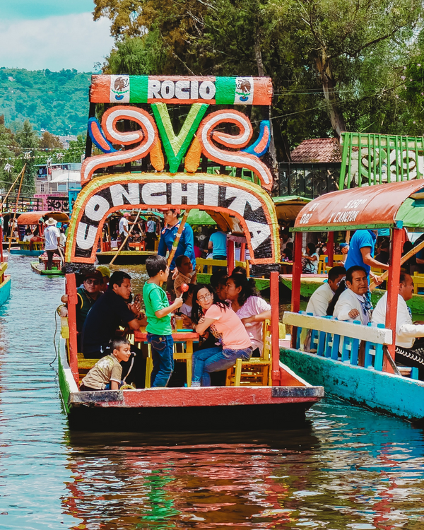 Colorful boat with 'Rocio' branding on a canal with people around
