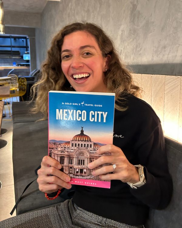woman showing her solo girls travel guide for mexico city