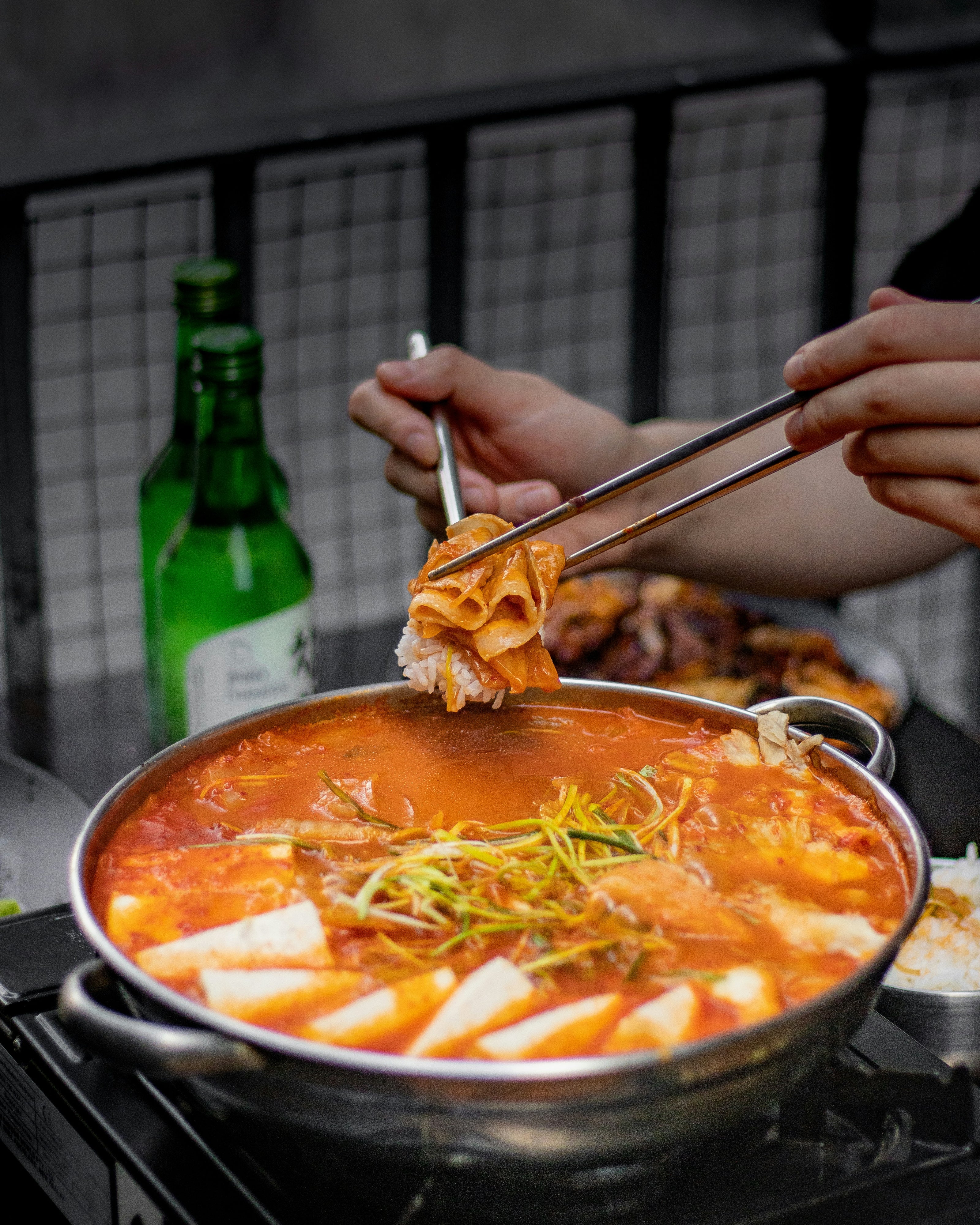 Hot pot being enjoyed with a bottle of beer in the background