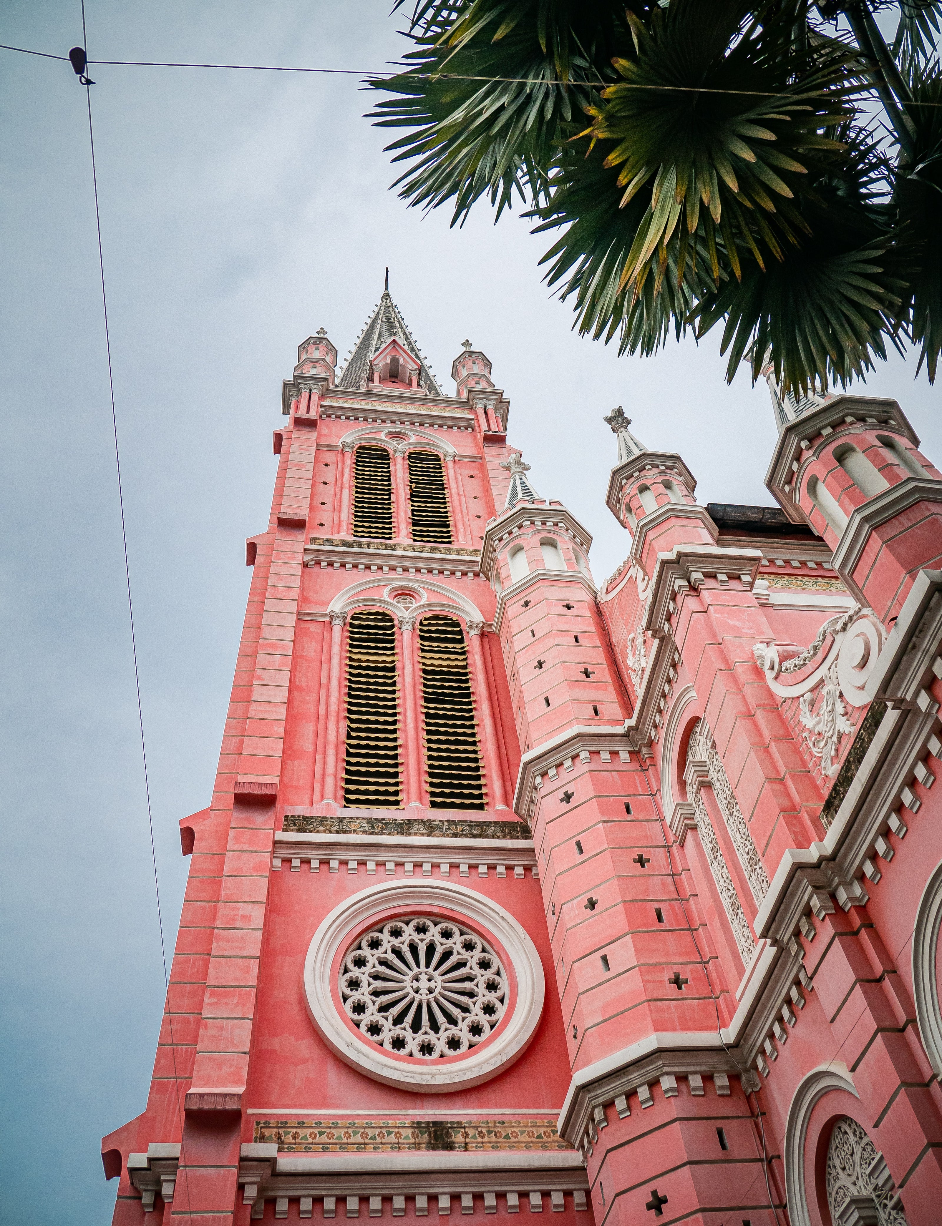 Pink cathedral with architectural details against a clear sky
