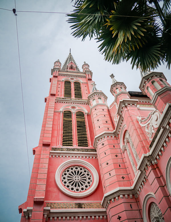 Pink cathedral with architectural details against a clear sky