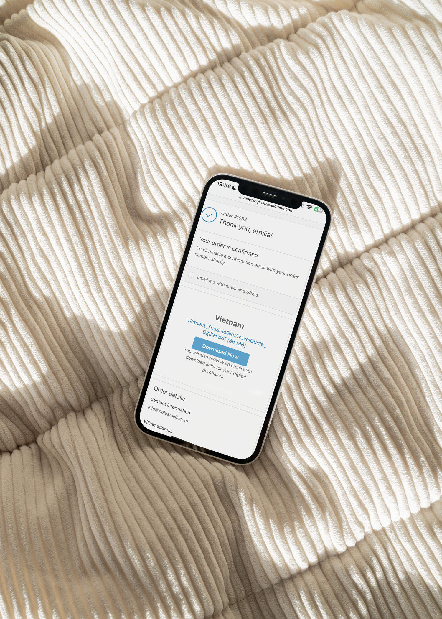 Smartphone displaying an order confirmation screen on a textured beige surface